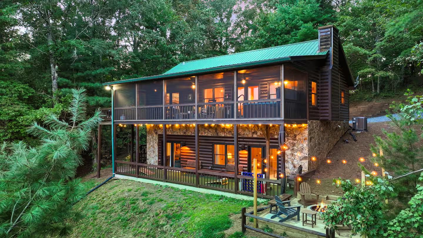 An aerial view of the back of the house reveals a spacious and inviting outdoor area, perfect for relaxation and fun. Enjoy the expansive deck, lush surroundings, and thoughtfully designed outdoor spaces.