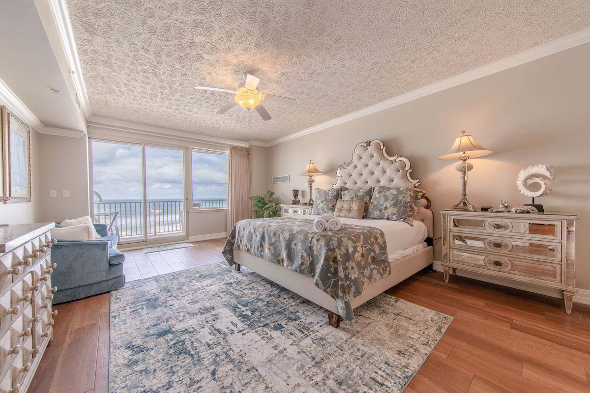 Primary Ensuite Includes a large Bedroom Area with Seating and a View of the Gulf From Either the Sofa or while lying in bed. It also includes a double-bowl vanity, a Large Tiled Shower, a Jacuzzi tub, and a private toilet room