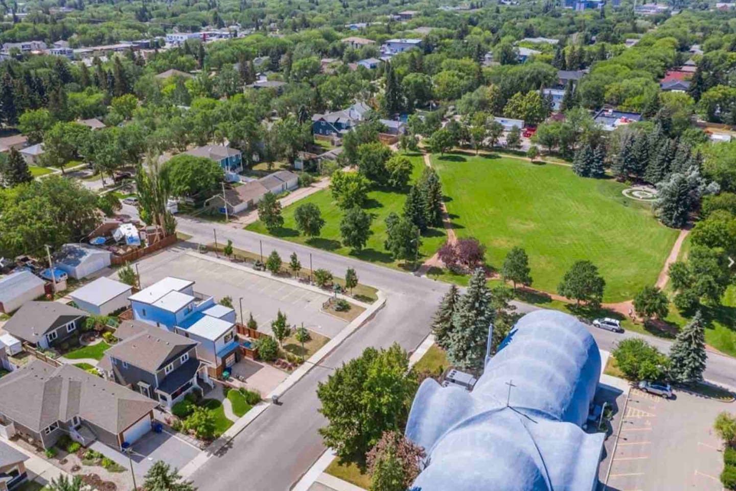 Exterior of the home where the suite is located, set on a quiet, tree-lined residential street.