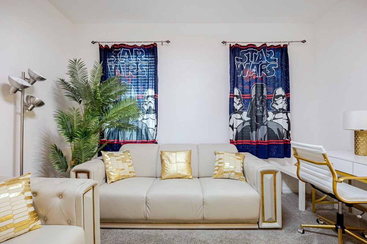 Living room 3: downstairs Star Wars-themed family room with cream-and-gold sofas and an electric fireplace.