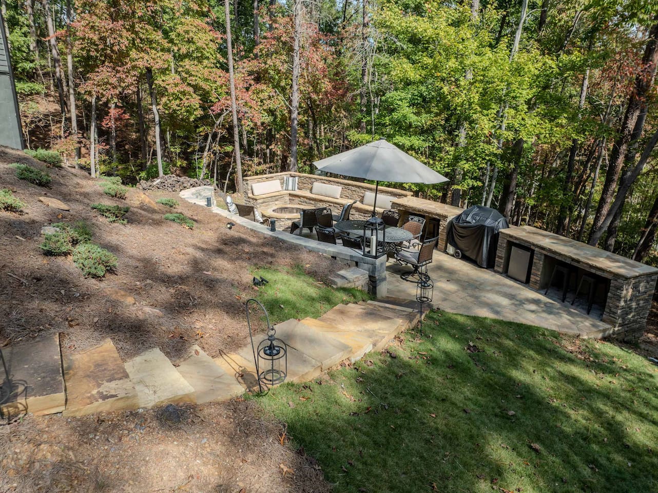 Stone steps leading from Screened Porch to Backyard area with Fire Pit