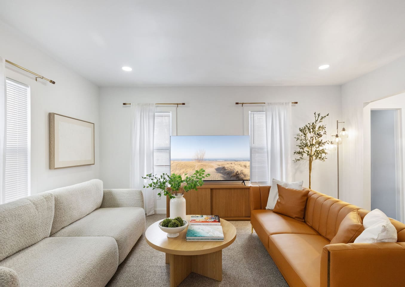 Comfortable living room with ample seating, natural light, and an open, inviting layout.