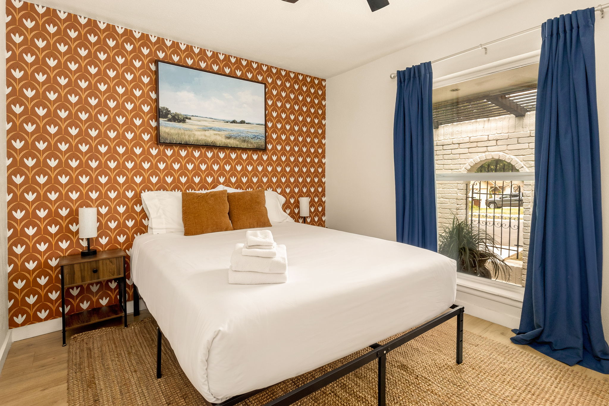 A bright and cozy bedroom featuring a plush king bed, blackout curtains, and a calming space designed for restful nights.