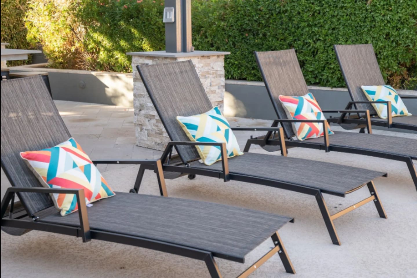 Poolside loungers with colorful throw pillows make for the perfect spot to soak up the Arizona sun.
