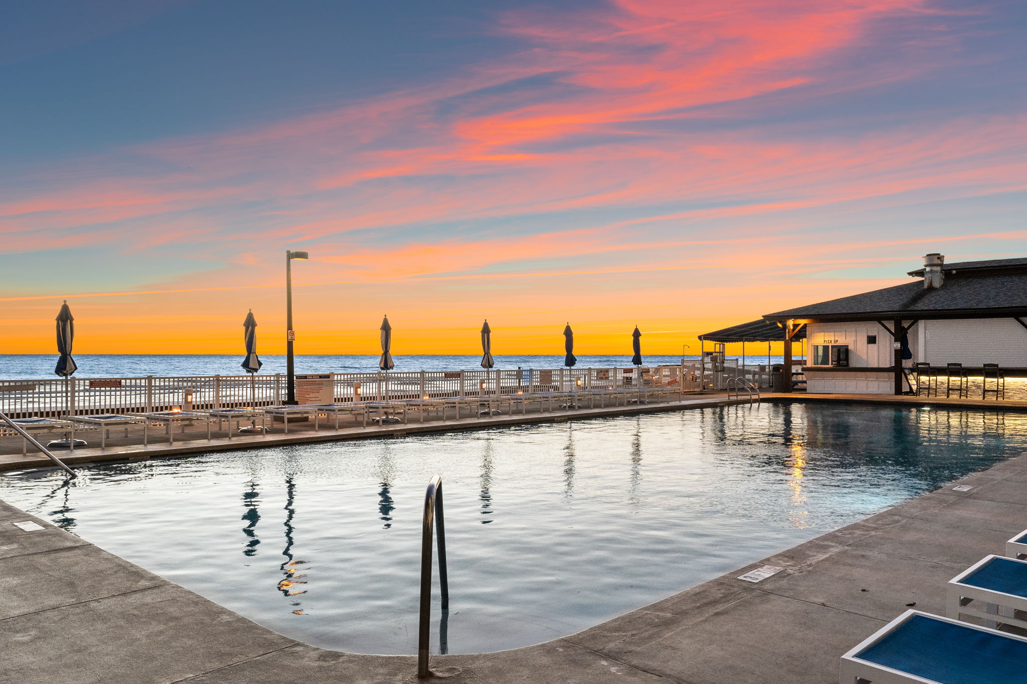 Twilight view across the pool to the sea