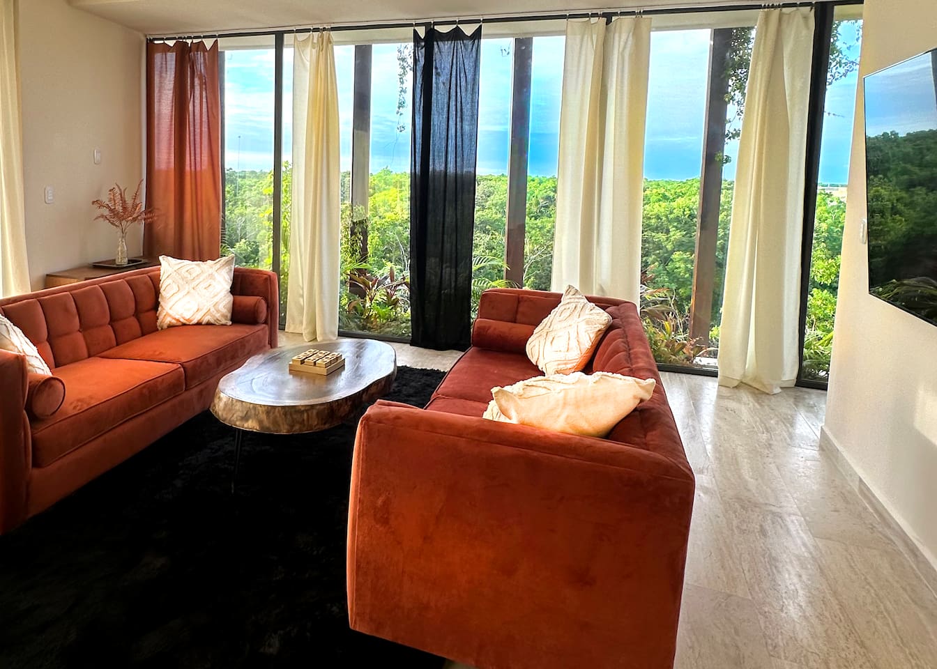 The living Area is surrounded by views of the Tulum jungle