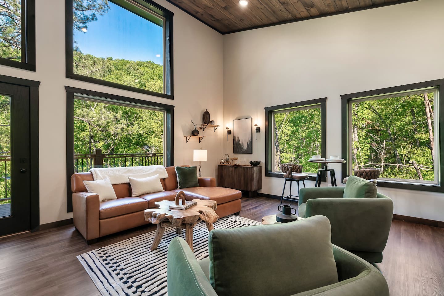 Open-concept living room with soaring ceilings and floor-to-ceiling windows.