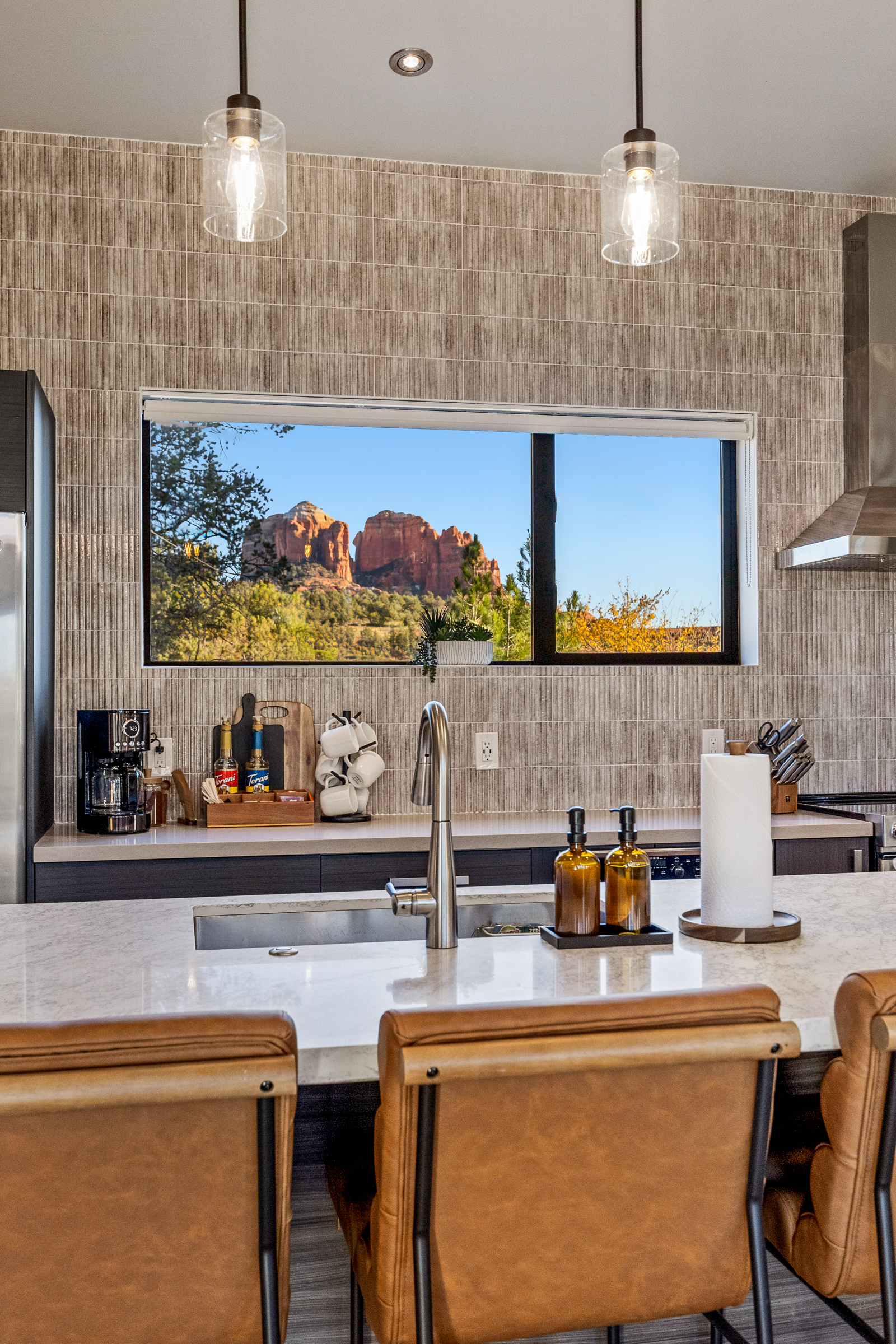 Red rock views frame the kitchen sink, bringing Sedona’s landscape into the heart of the home.