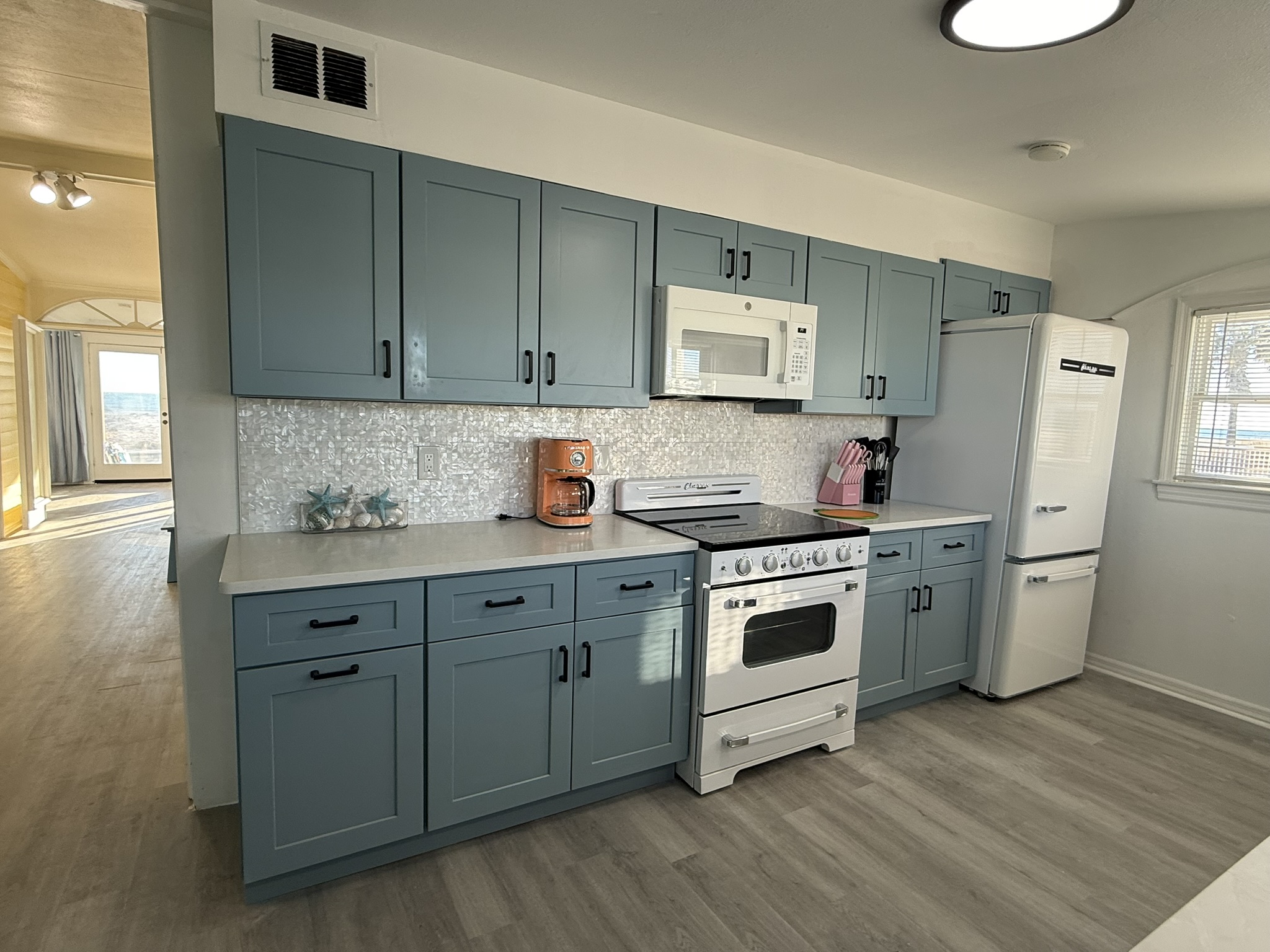 Blue Kitchen Cabinets with Retro Appliances and Mother of Pearl Backsplash!