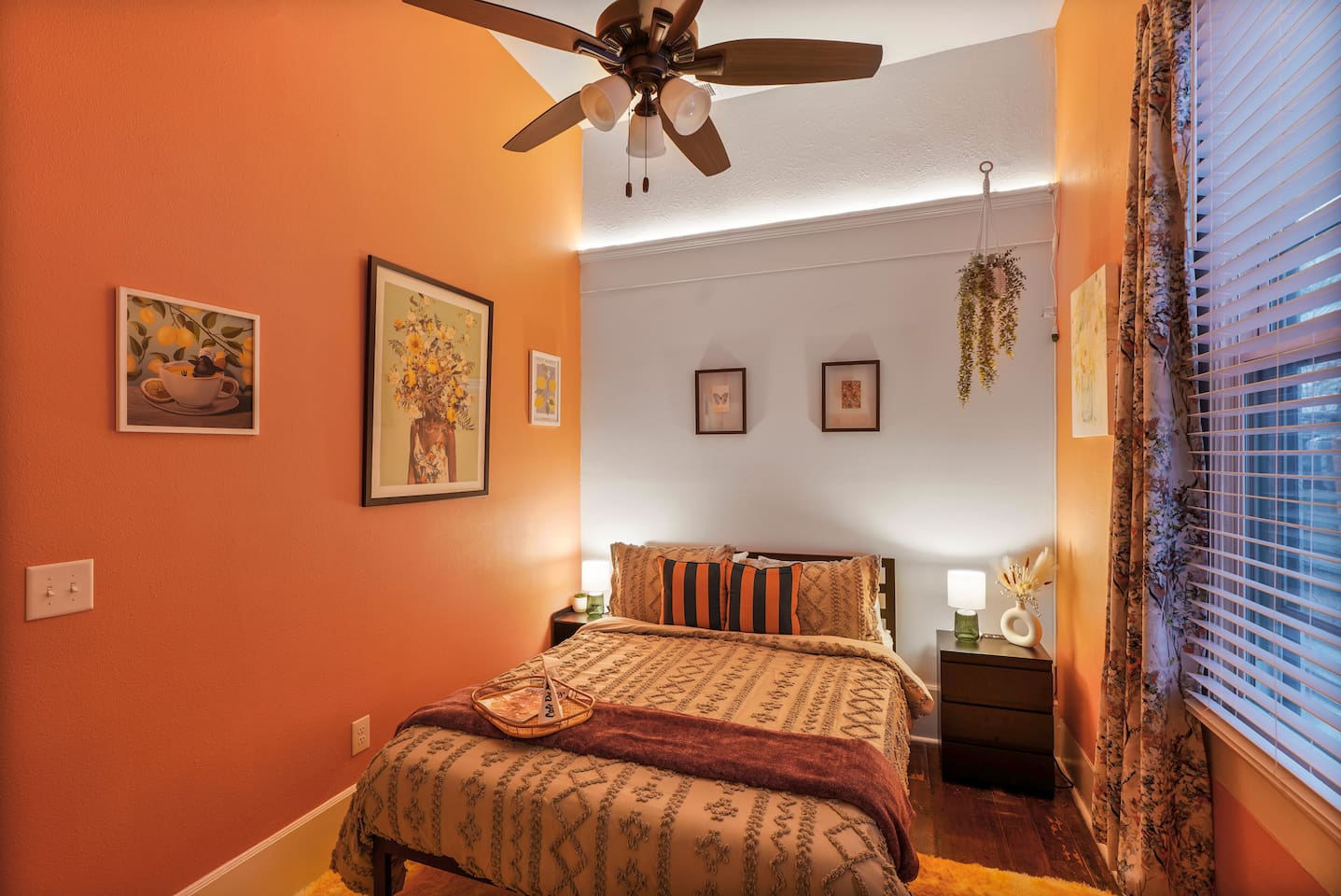 Recharge in the Pink Room with a comfy queen bed, luxe bedding, local art, full-length mirror, closet, pack ’n play, and ironing board.