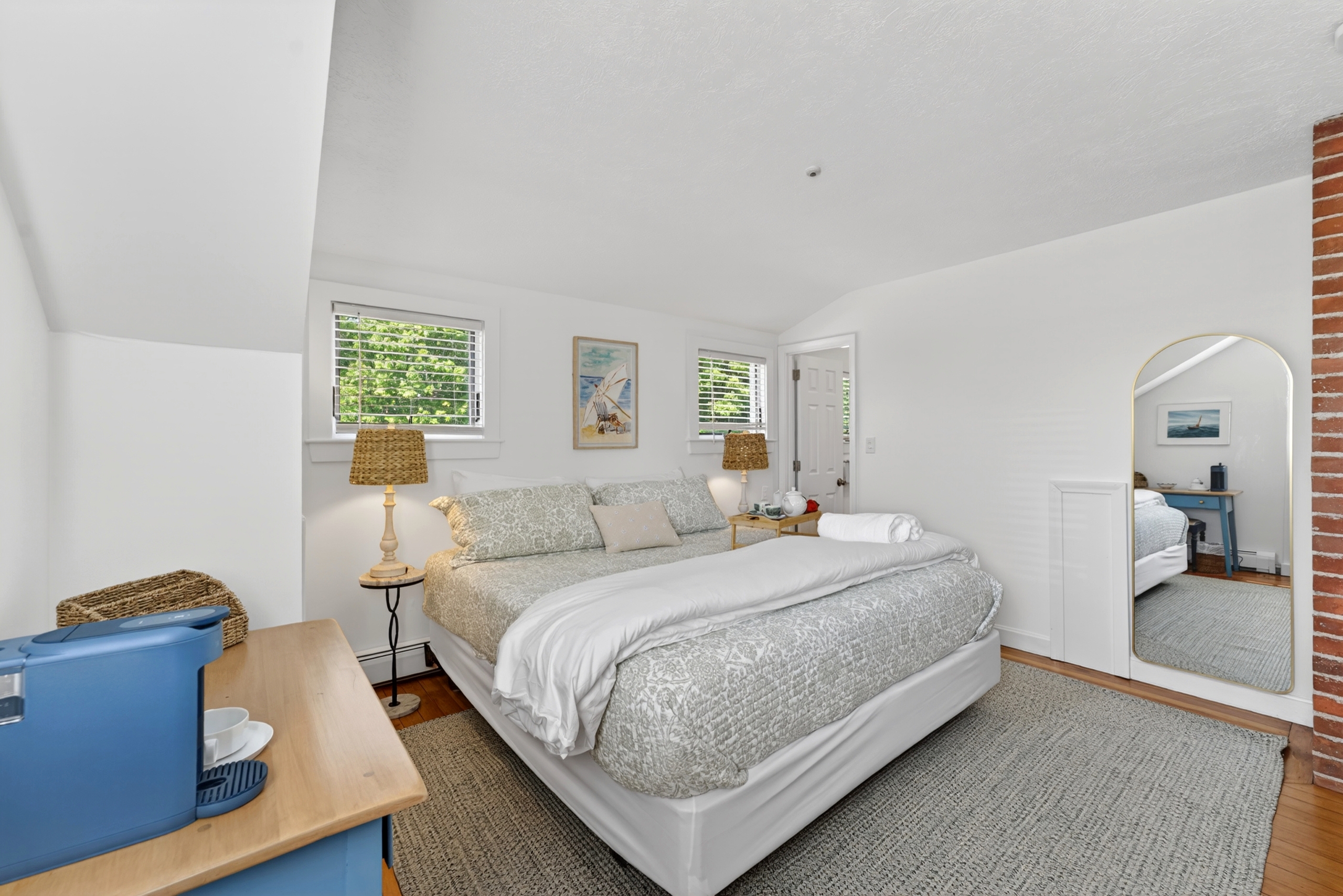 Upstairs king suite with ensuite bath, workspace, and coffee setup