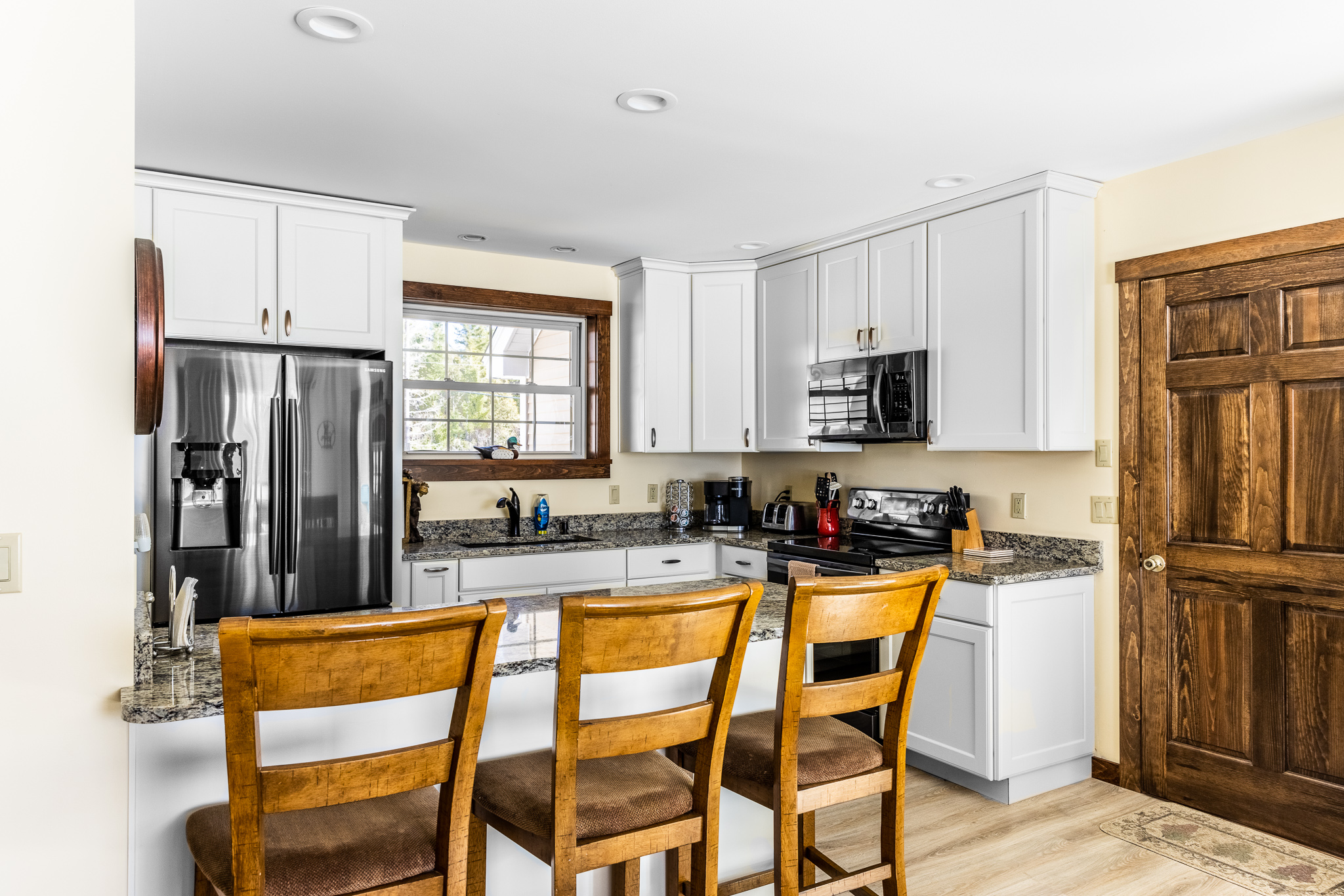 Kitchen counter with 3 seats.
