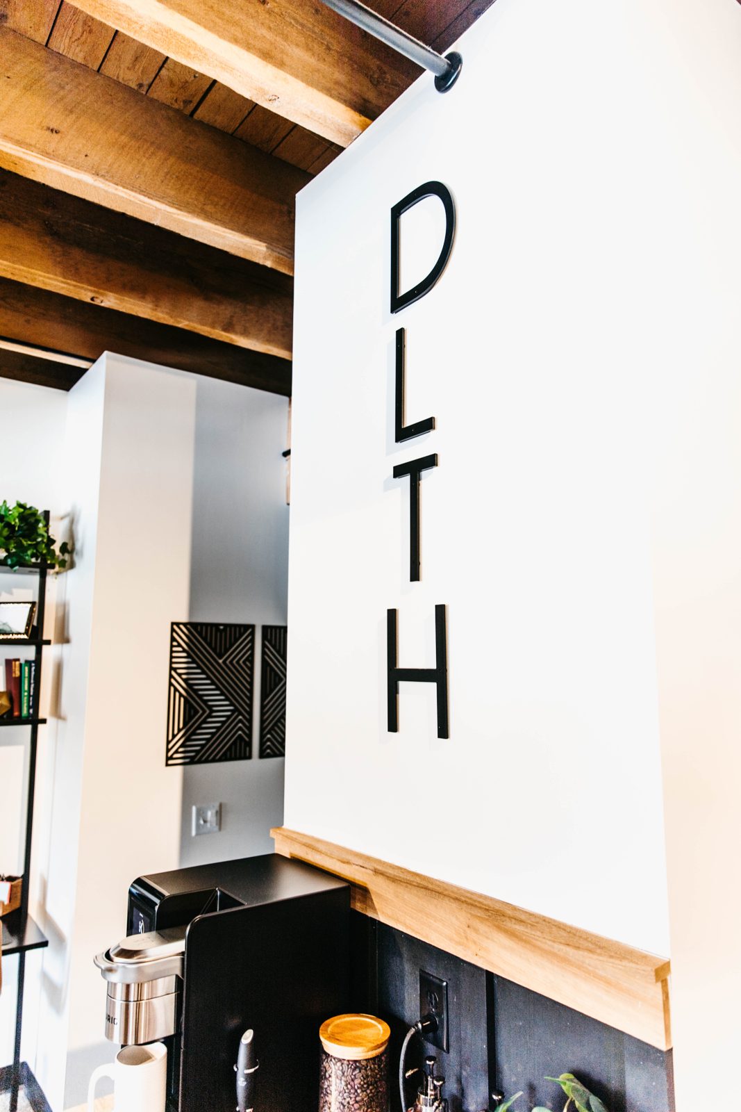 A DLTH sign in a Brix condo with Douglas Fir beams in Canal Park, Duluth