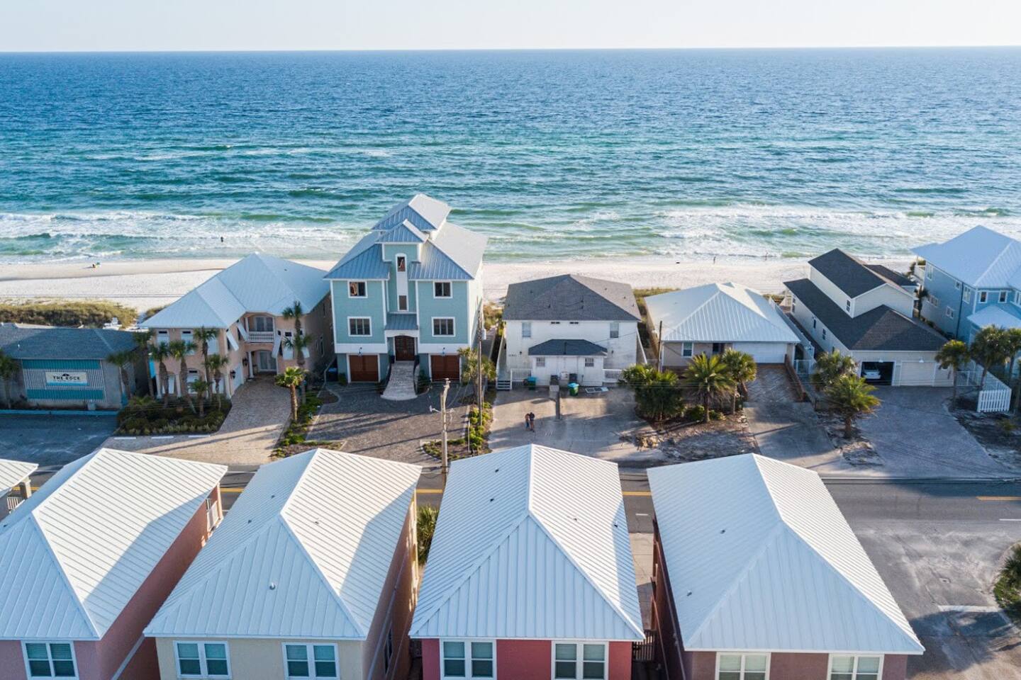 The entrance to the Riviera Beach Villas private beach is just to the right of the green house right across the street.