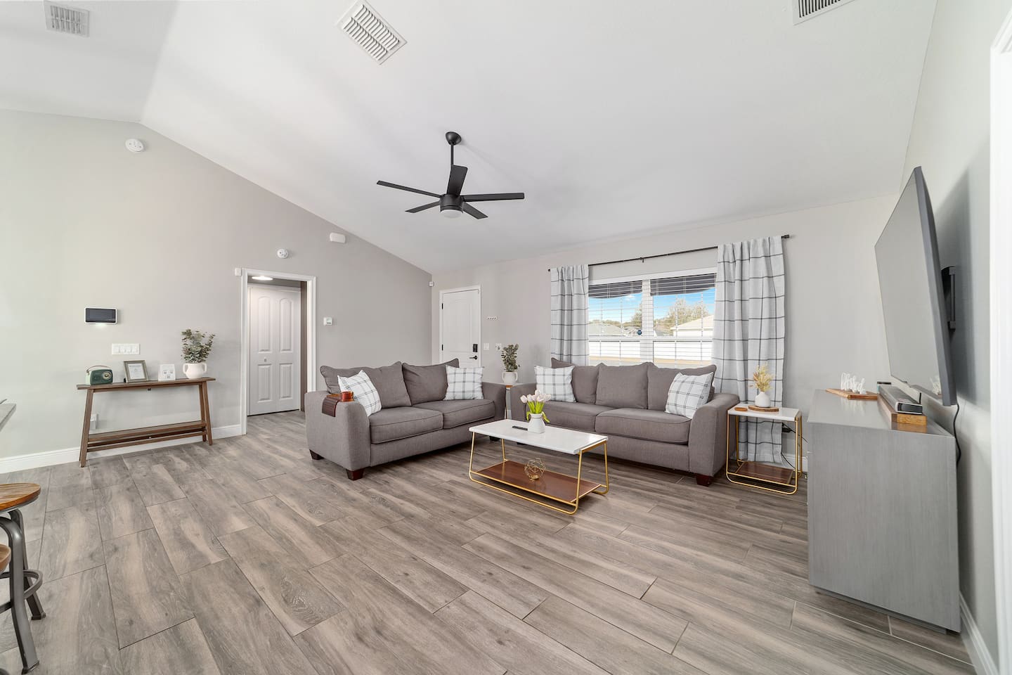 Unwind in this bright, modern living room featuring plush seating, and stylish decor. With plenty of natural light and comfortable spaces to relax, it’s the perfect spot for movie nights and spending time with family!