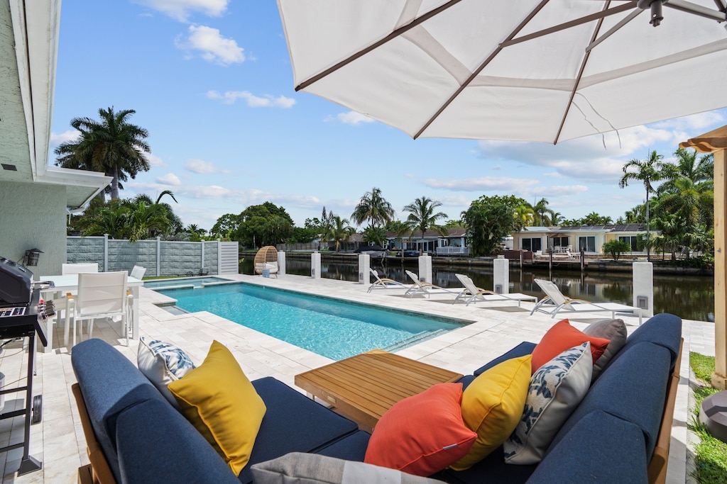 The large umbrella offers comfortable lounging outside by the pool.