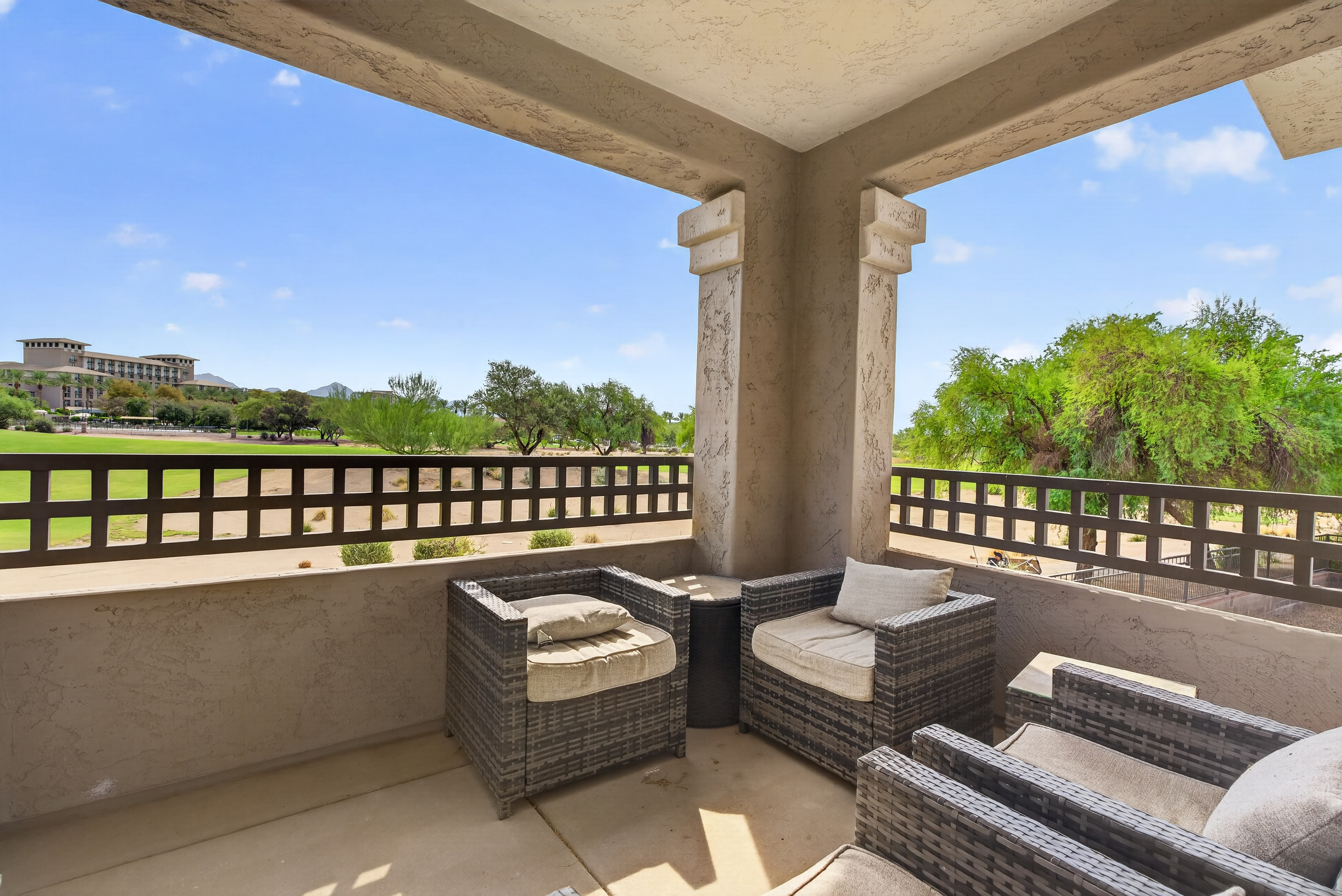 Covered balcony with outdoor seating and open desert views for coffee, reading, or fresh-air downtime.