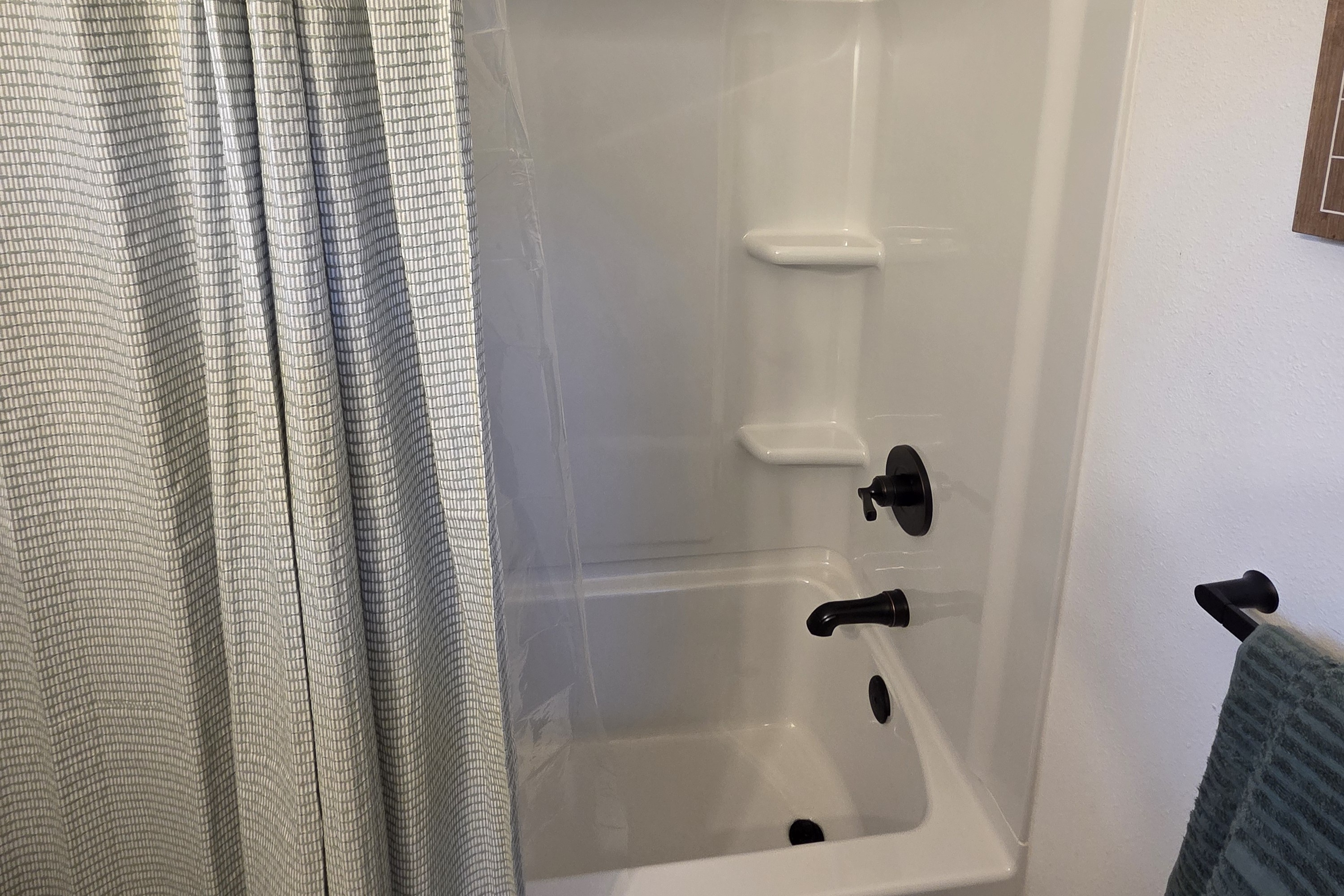 Bathroom includes vanity, toilet, and shower/tub combo.