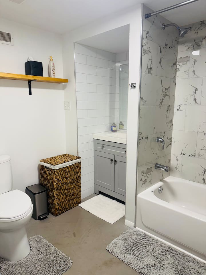 Clean bathroom with modern fixtures and guest essentials.