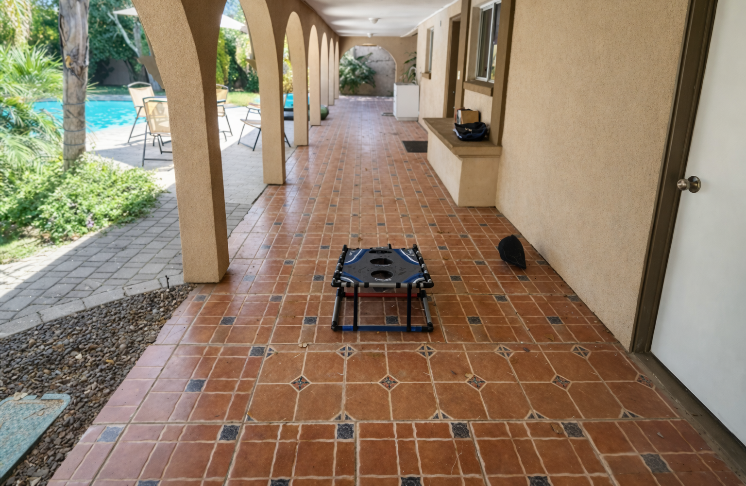 This breezy covered patio with classic tile flooring is ideal for sipping morning coffee, lounging in the shade, or enjoying the desert breeze.