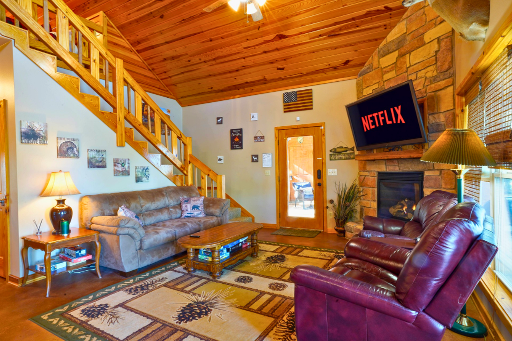 Cozy stone fireplace seating area — perfect for fall & winter stays.