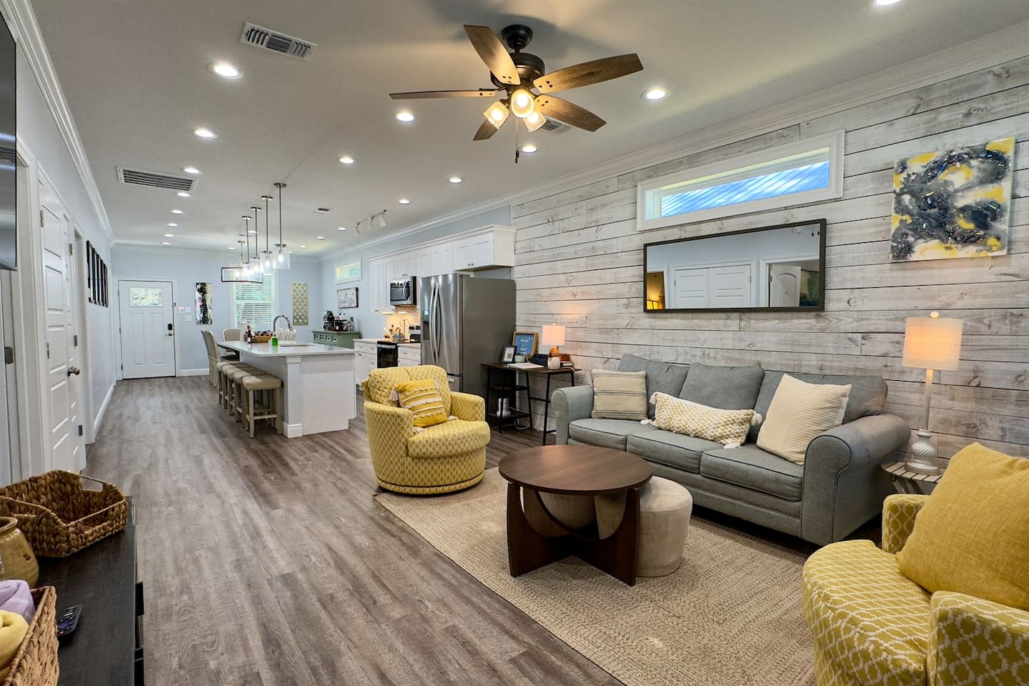 Where sleek design meets cozy charm—living room and kitchen in harmony