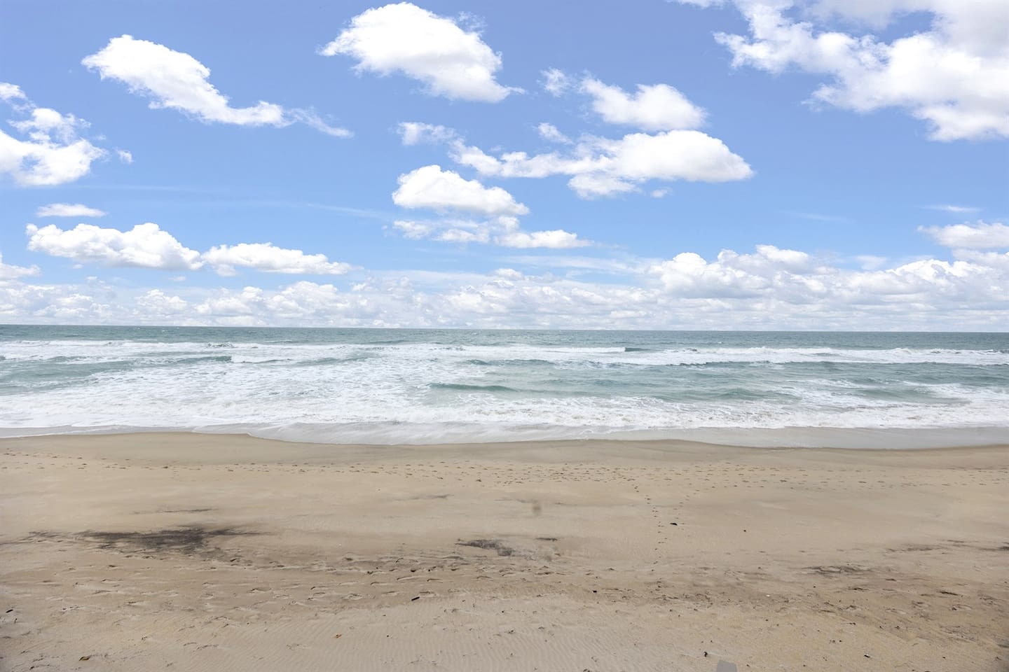 Relax in the backyard with a stunning ocean view, where soft white sand meets the shimmering waters, offering a peaceful and scenic retreat right in front of the ocean.