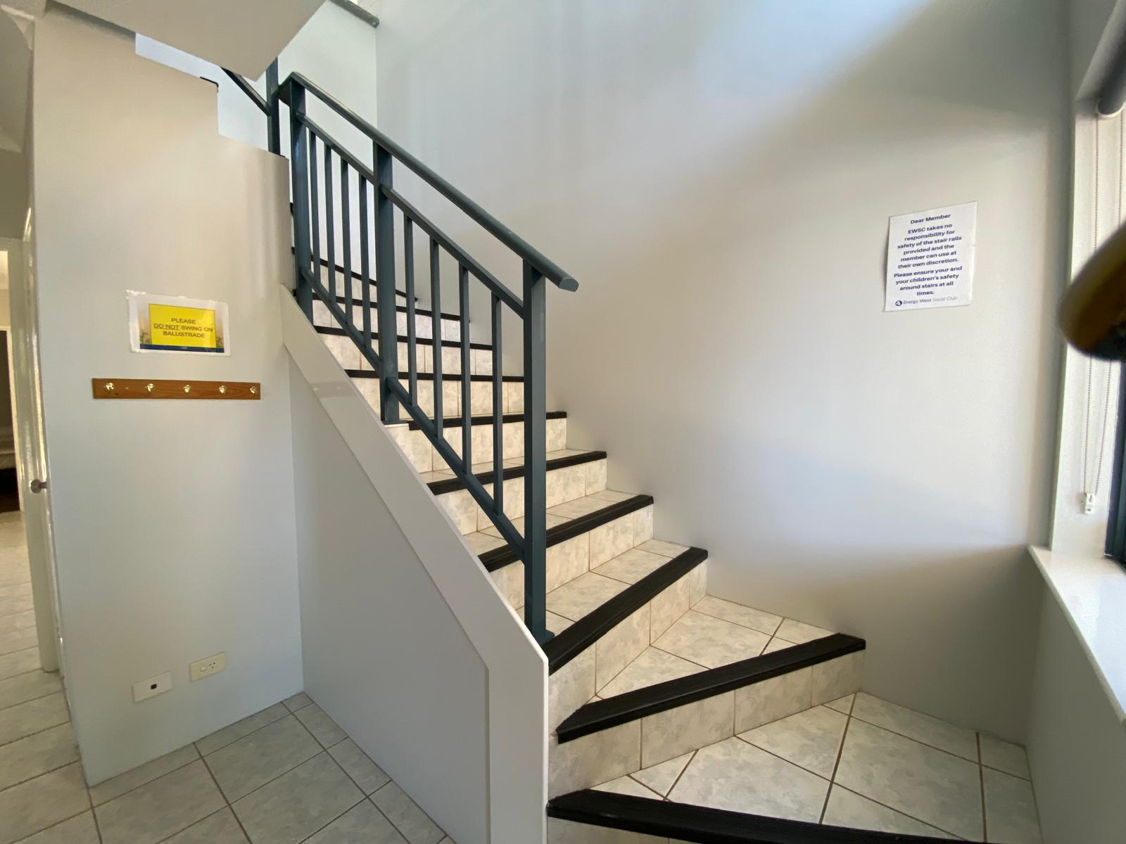 Staircase leads up from front door to the kitchen / living