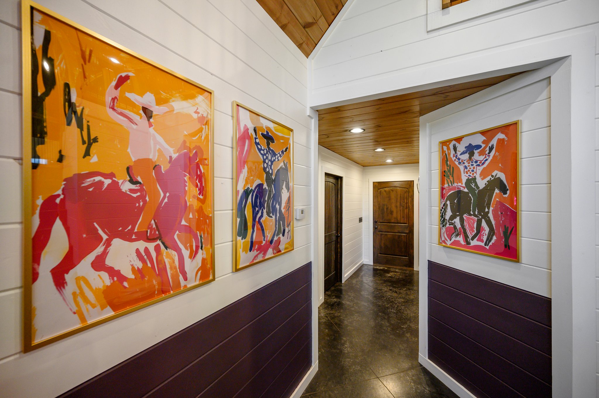 Framed cowboy artworks on the hallway, bringing a touch of the Wild West to the space!