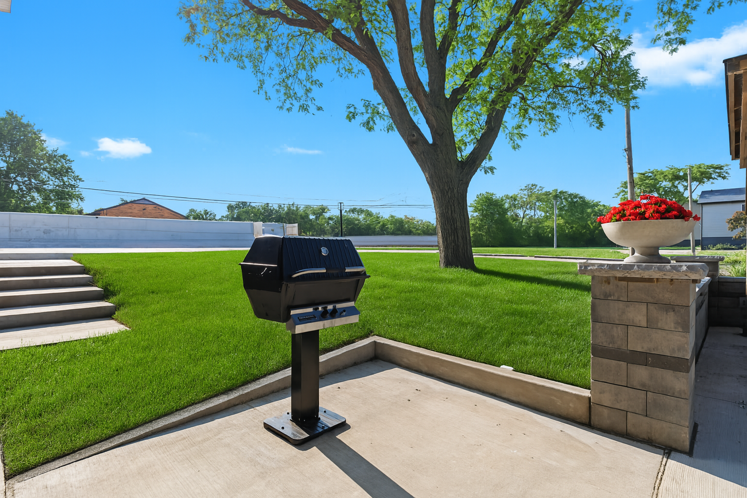 Relax and cook outdoors at the on-site grill station, surrounded by well-kept landscaping.