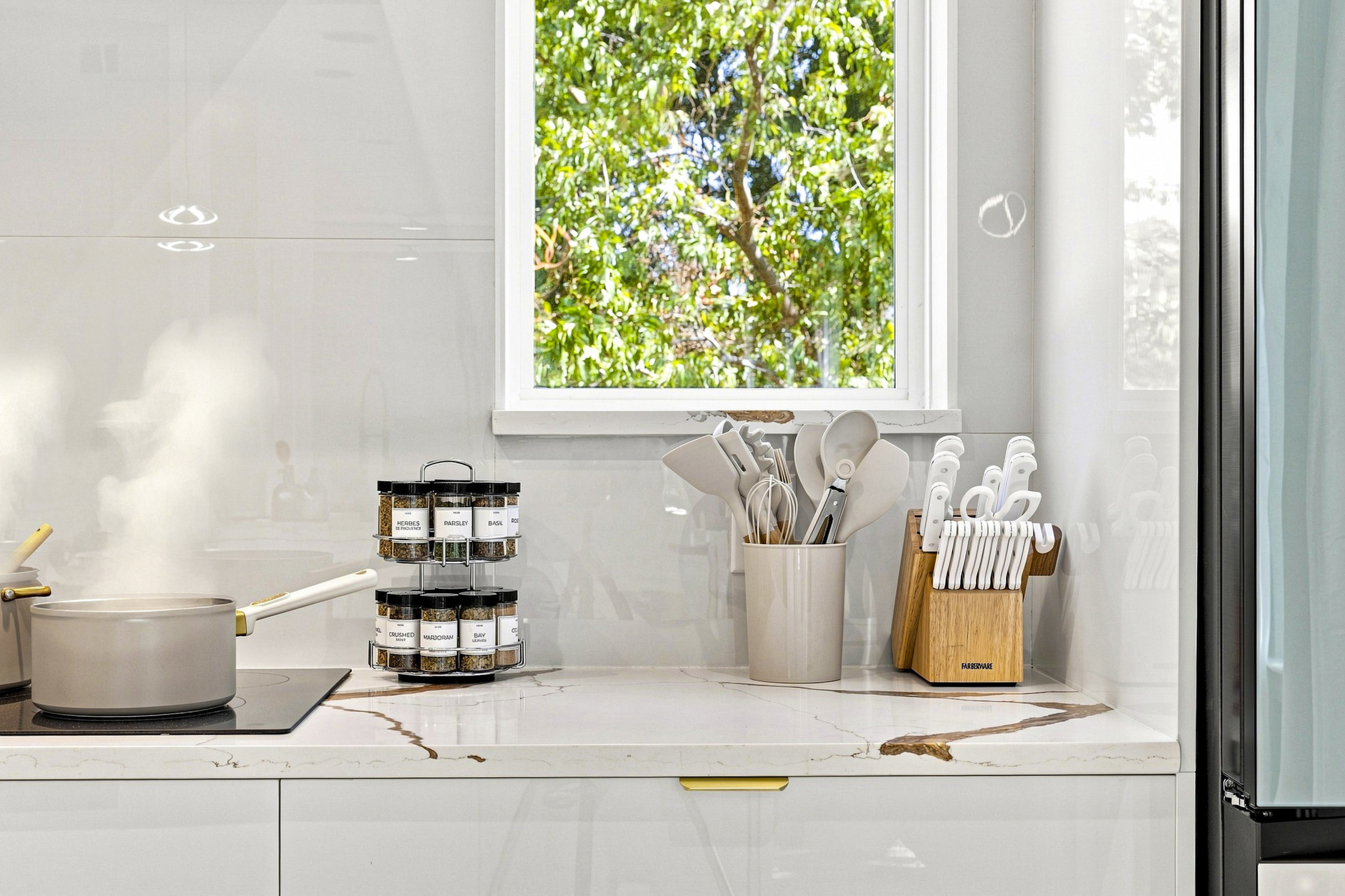 Gourmet delights await in a sunlit kitchen with top-notch amenities and fresh views!