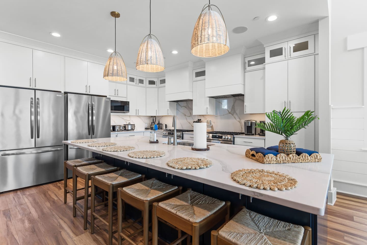A kitchen built for a crowd! The oversized island with barstool seating is the perfect gathering spot, while two refrigerators, two ranges, two ovens, and two dishwashers make feeding your group a breeze.