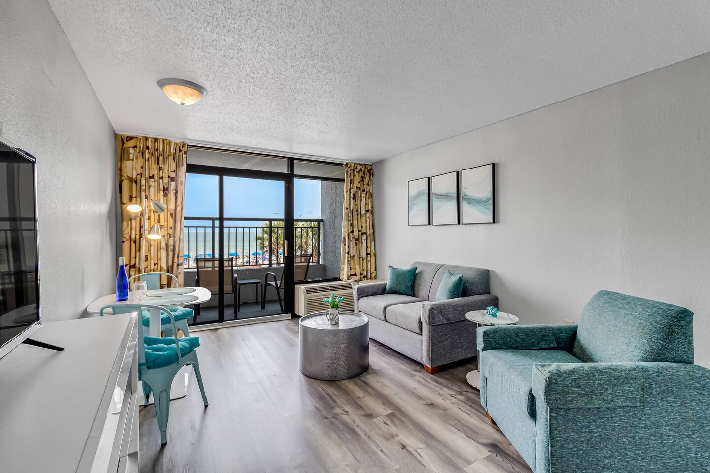 Allow the gentle sea breeze and soothing sound of waves to create a calming soundtrack for your time spent in the living room, enhancing the overall coastal experience.