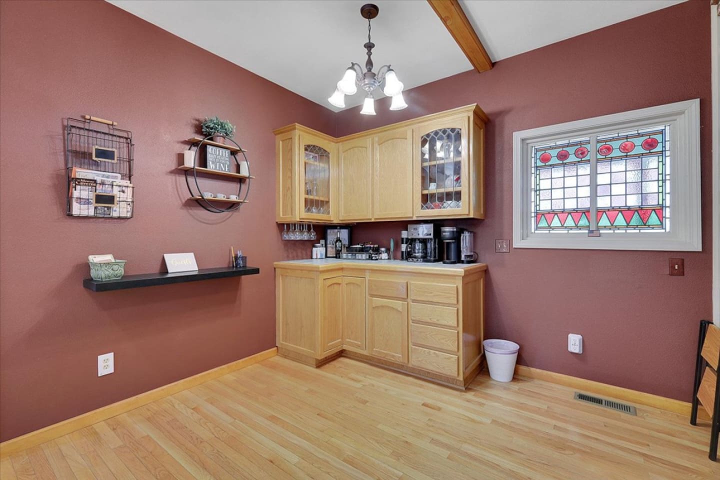 Coffee, tea, and wine station with extra cabinet storage beside the dining area.
