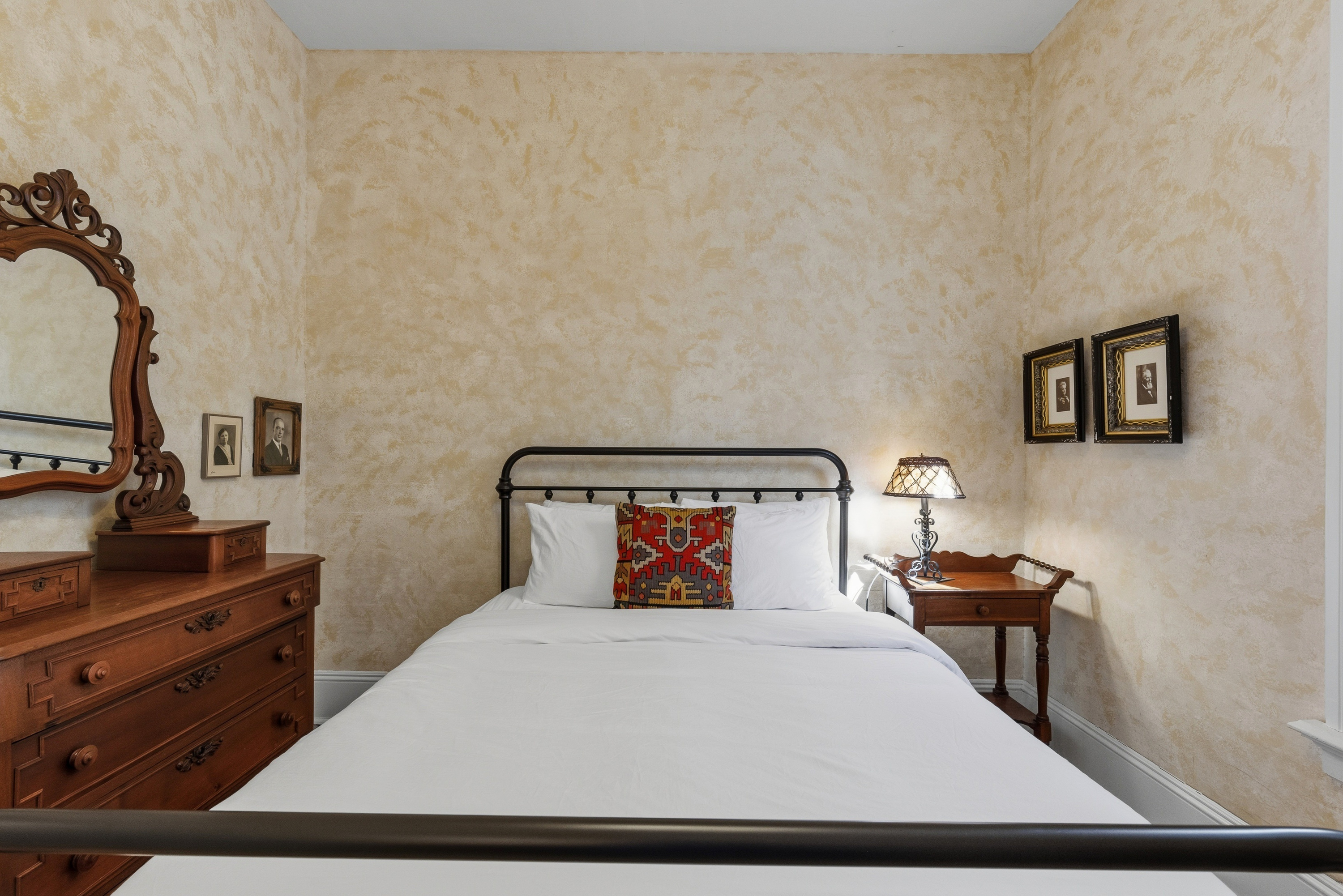 Queen bedroom w/ soft lighting & vintage-style decor