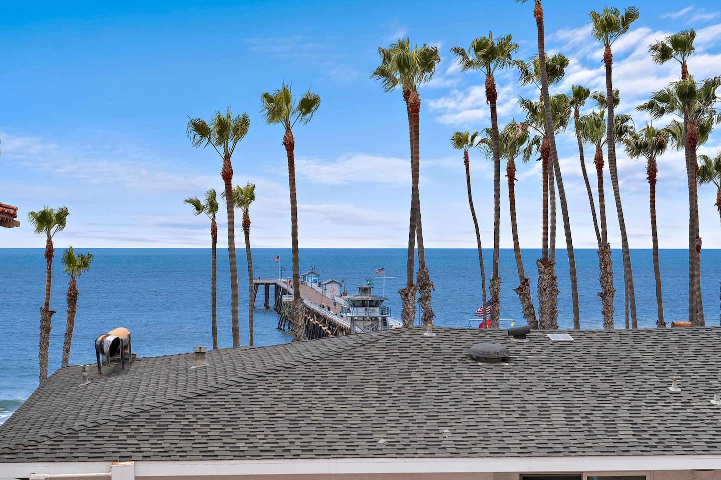The view is full of palm trees and a vast horizon. Gentle ocean breezes and the sounds of waves will remind you just how close you are to the pier and the beach.