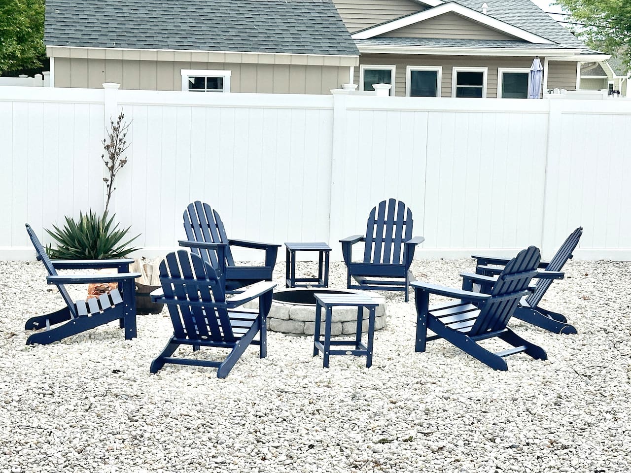Gather around our stone fire pit for the ultimate evening under the stars. With six comfortable blue Adirondack chairs set on a tidy gravel base and enclosed by a privacy fence, it’s the perfect spot for roasting marshmallows and making memories.