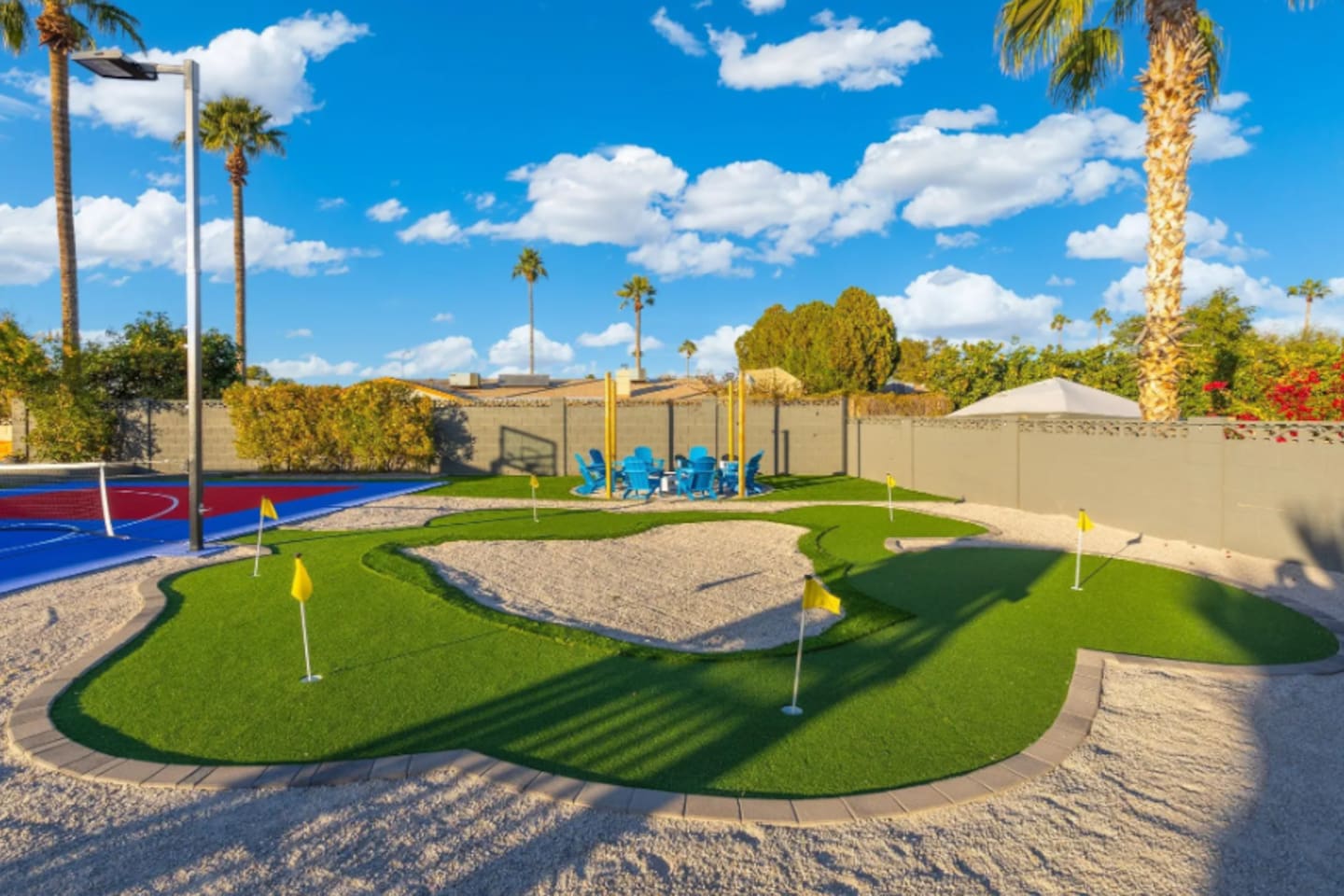 Multiple greens and flags make this putting course feel like its own mini golf getaway, shaded palms included.
