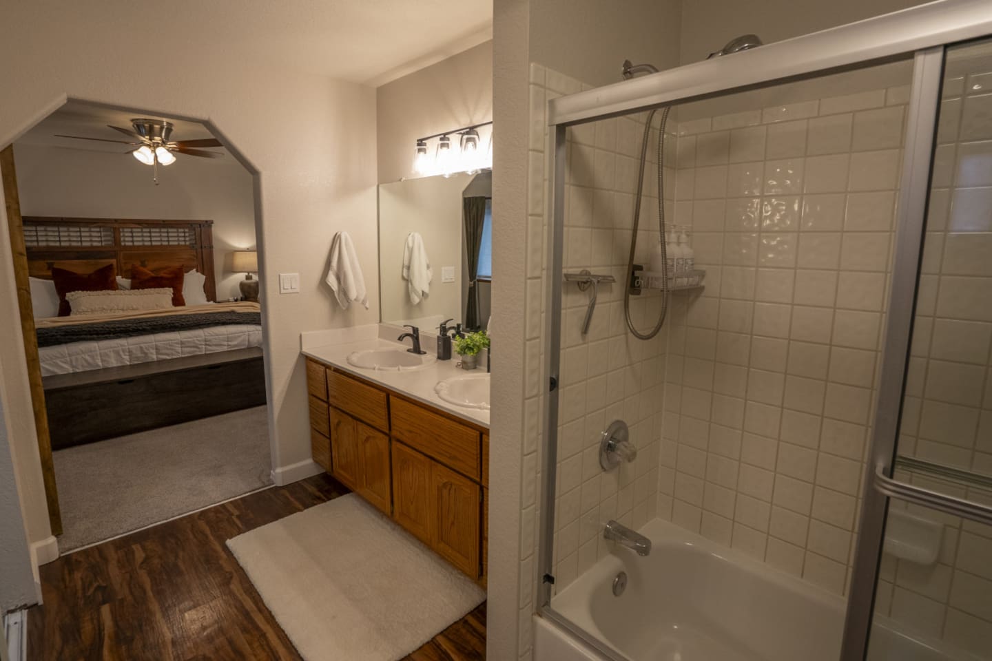 Ensuite-style bathroom with double sinks, tub/shower combo, and easy access from the bedroom.