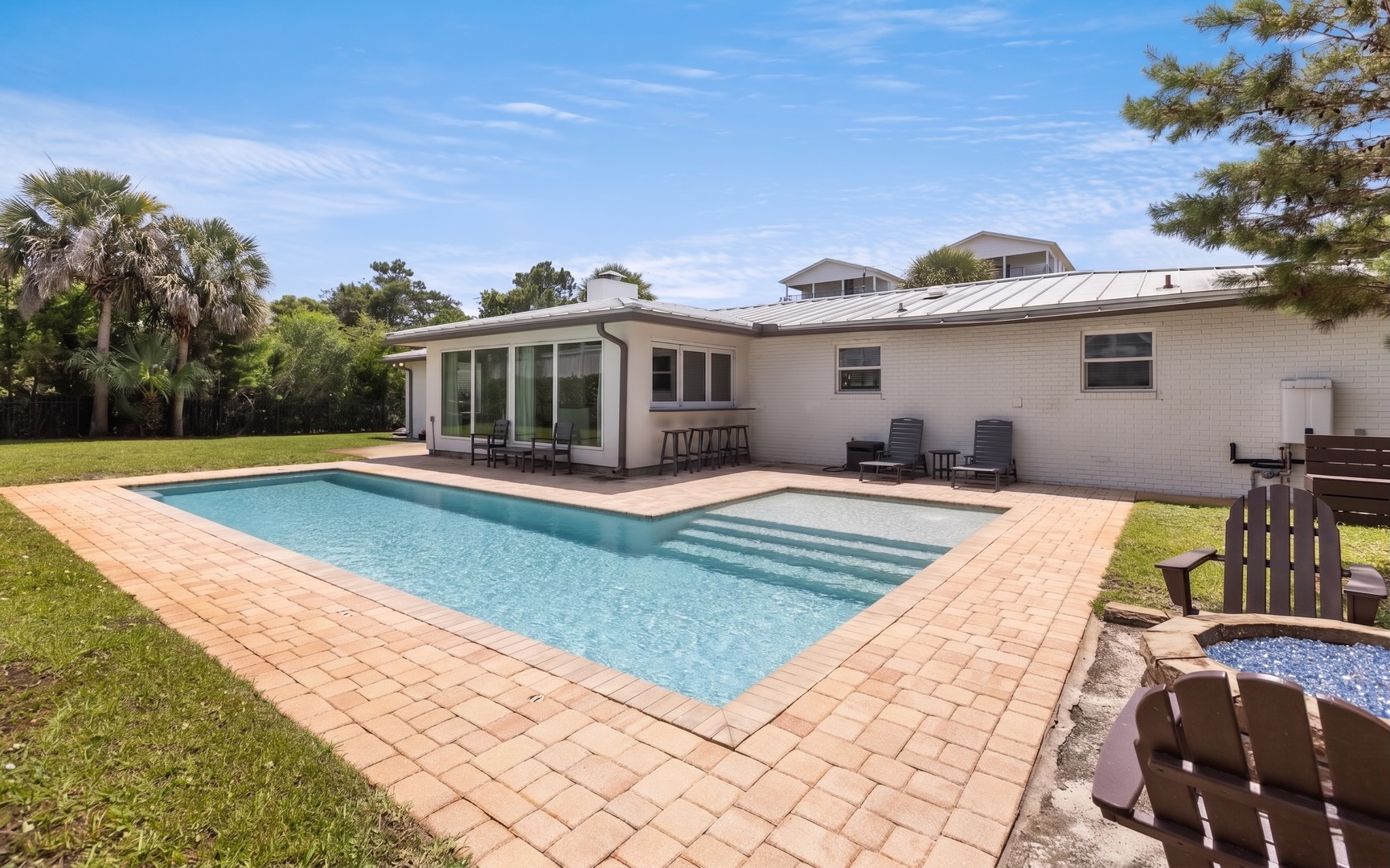 A private pool anchors the backyard, setting the scene for long afternoons under the Florida sun.