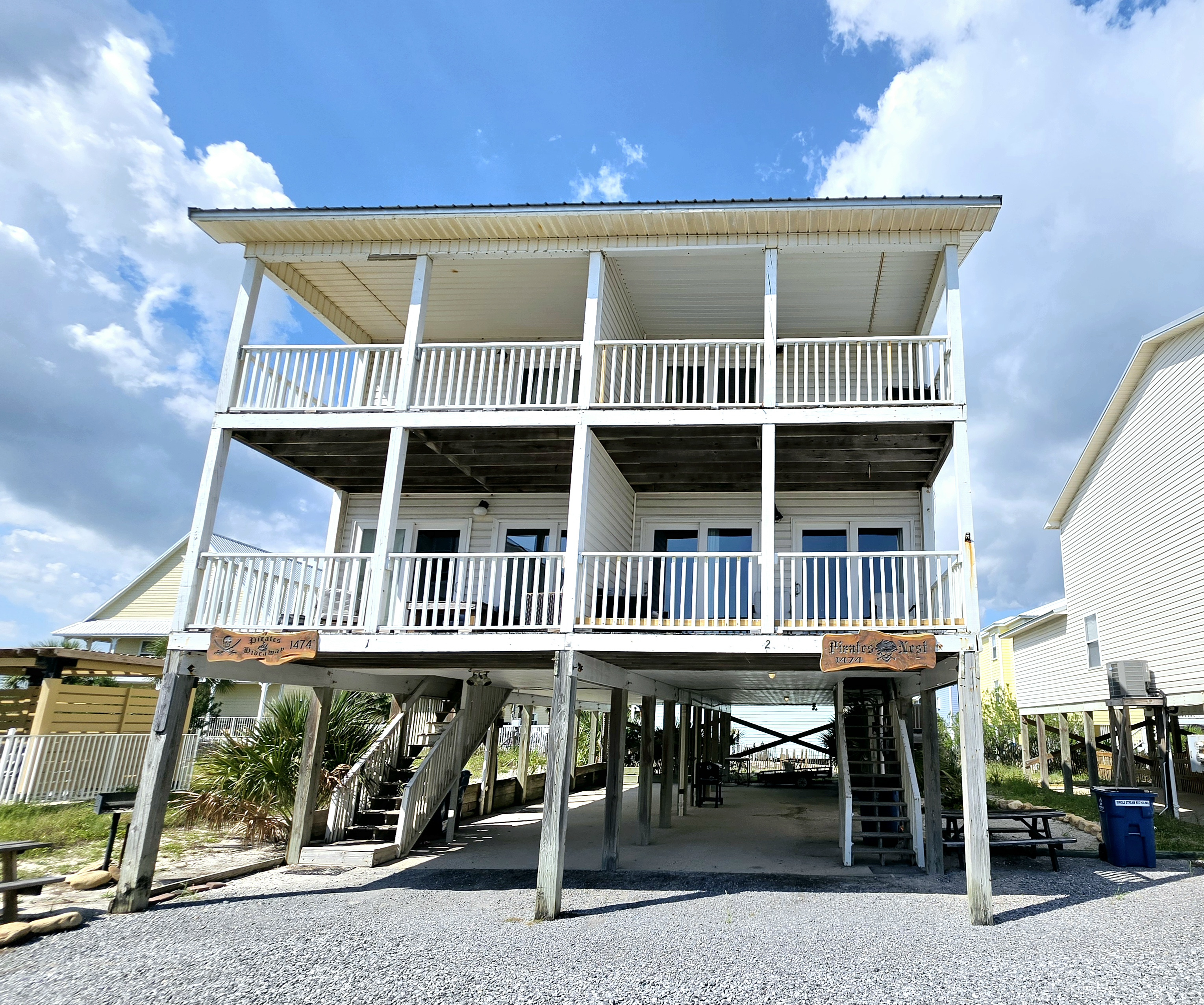 The duplex from the front, with parking and stairs under each side