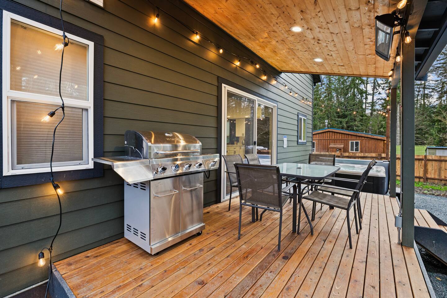 A large outdoor grill for your enjoyment. Grilling tongs and turner available in the kitchen. String lights add to the festive feel