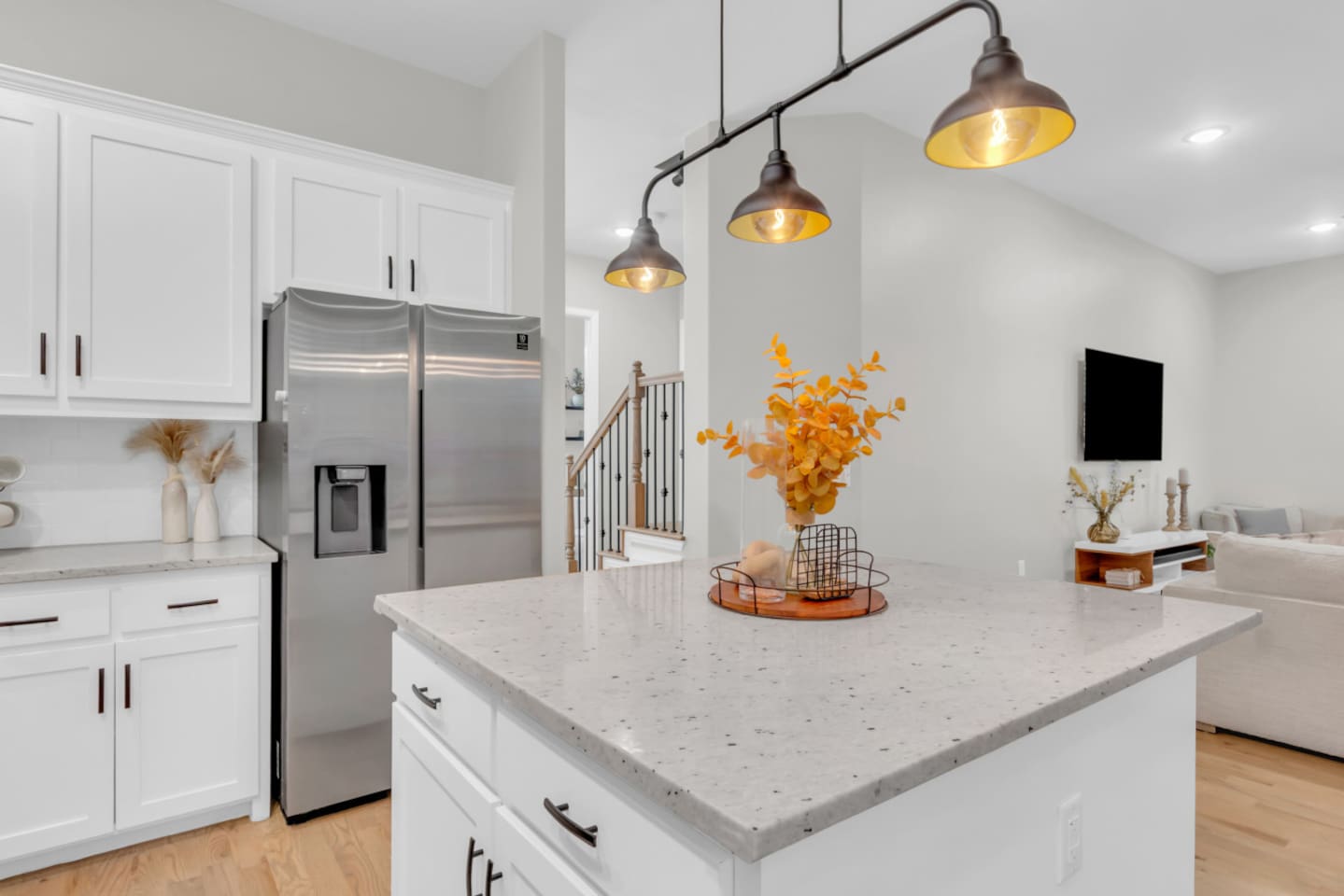 Chef’s kitchen with large island and sleek white cabinetry.