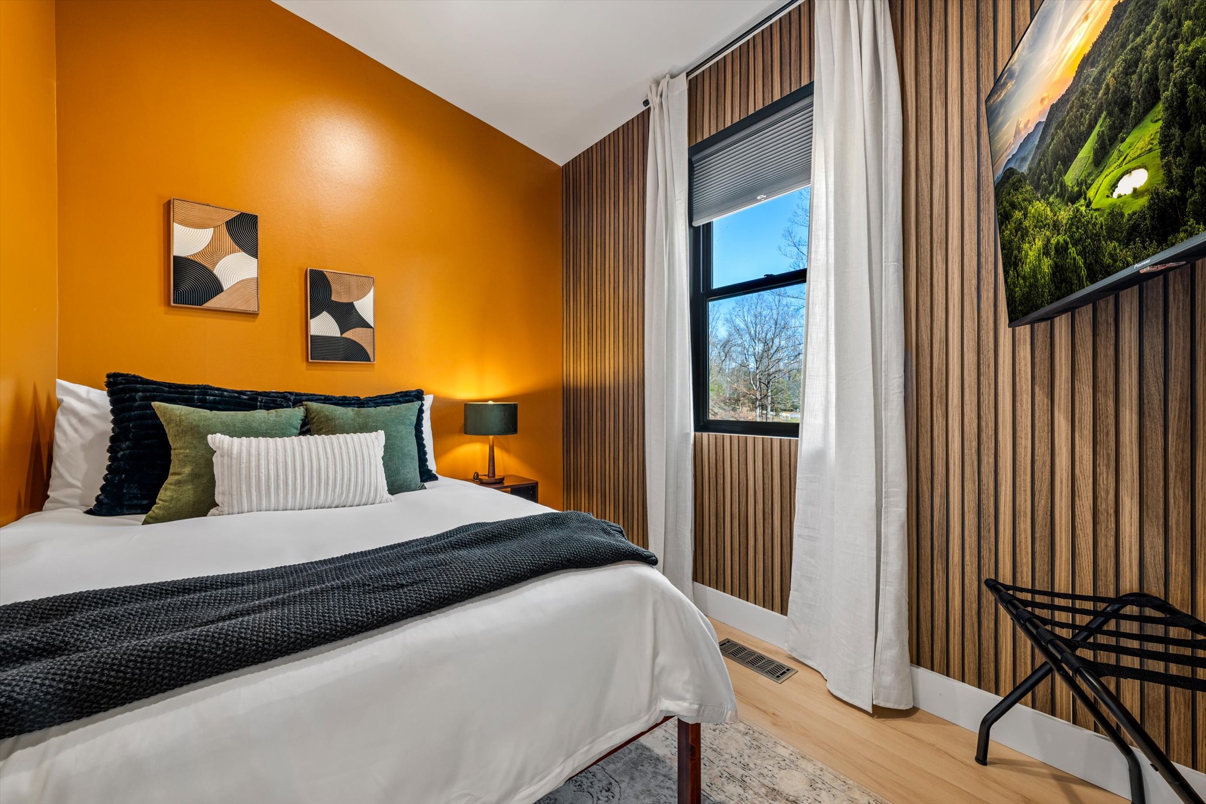 {Full Bedroom}
A cozy, design-forward space — full bed, 55 in TV, midcentury modern artwork, and hotel-grade luggage storage for a stay that feels simple and elevated.
