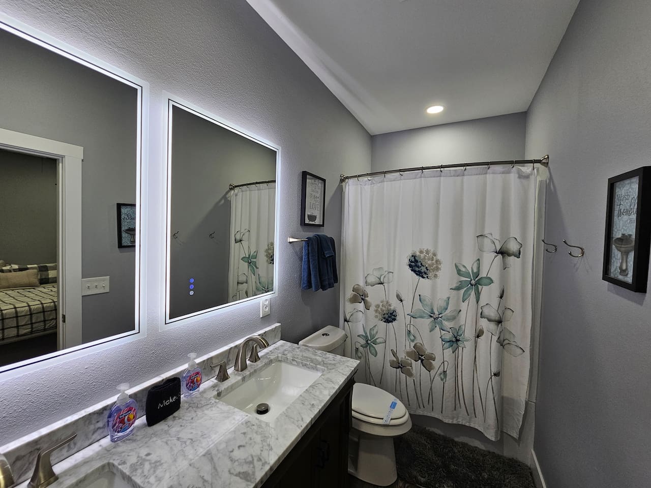 Clean and inviting bathroom with full tub, fresh linens, and plenty of lighting.