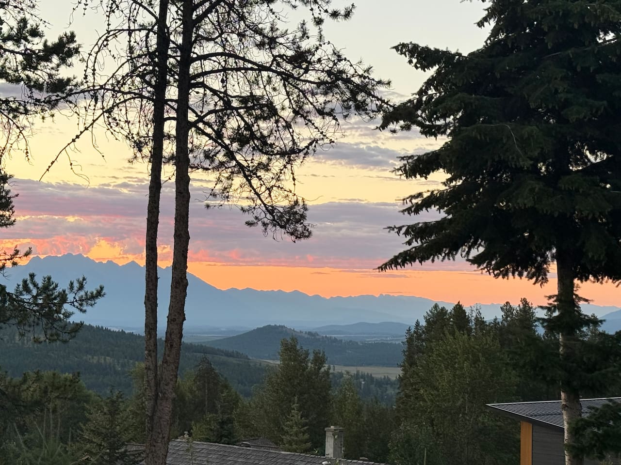 Mountain Panorama: A breathtaking east-facing view from the private deck overlooking the Rocky Mountain range during a golden sunrise.