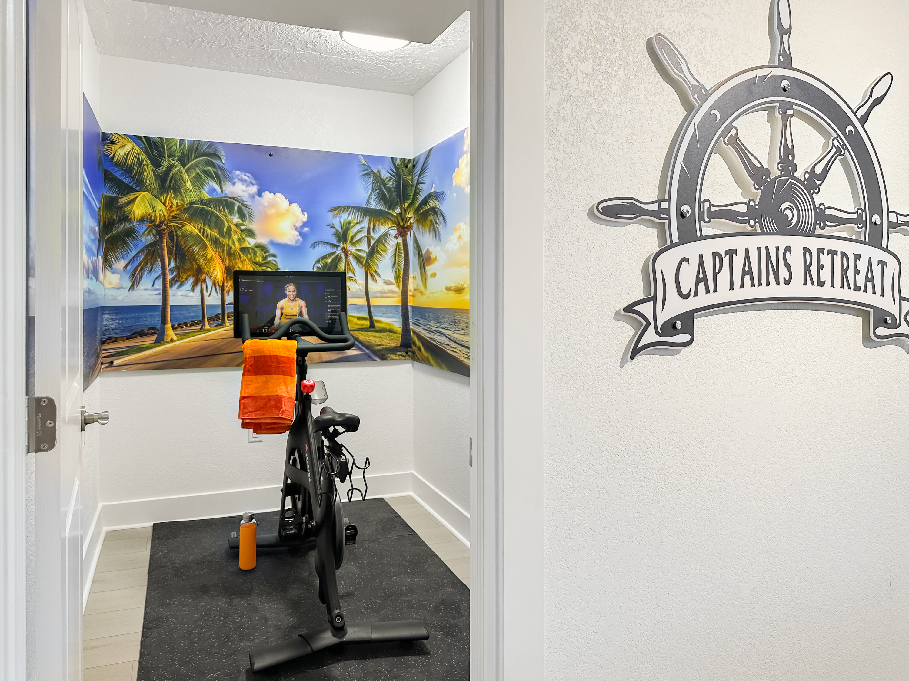 Around the corner is the gym with a Peloton bike and free weights.