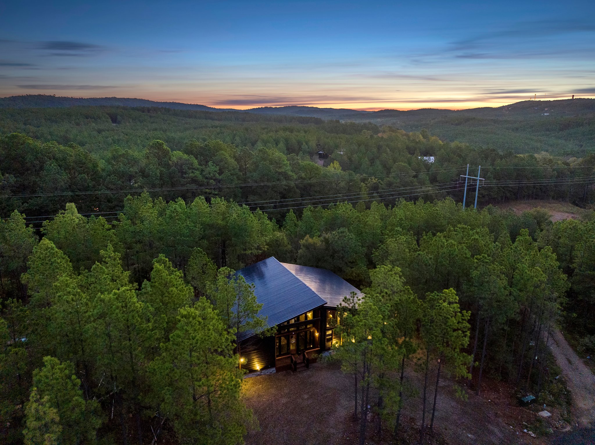 Secluded cabin retreat surrounded by forest and stunning sunset views