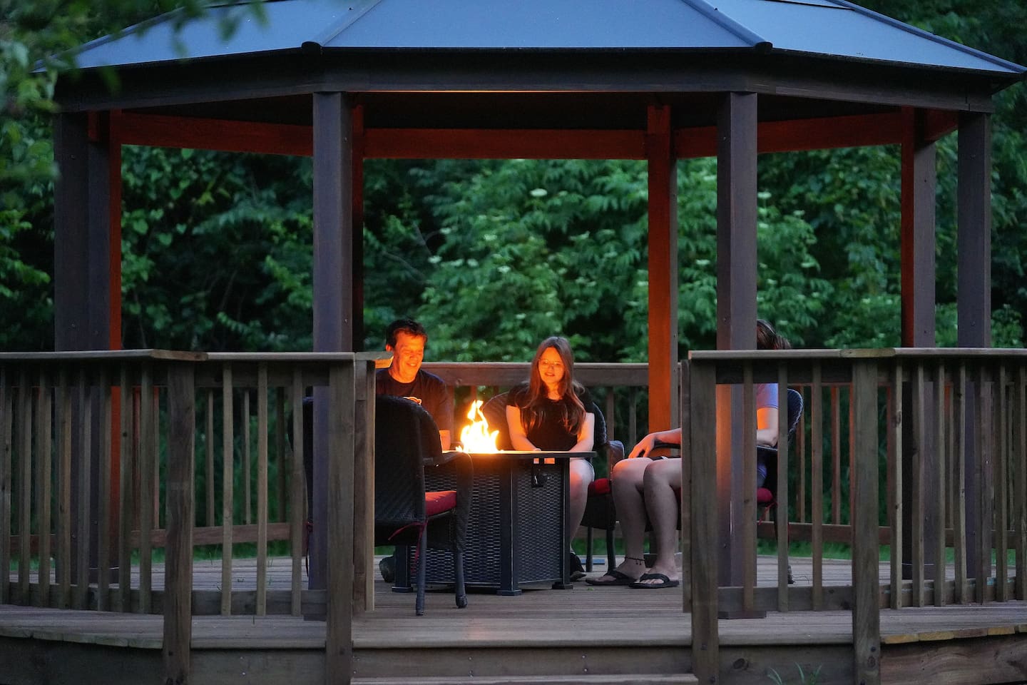 Bask in the warm glow of the fire table in the gazebo in the evening. 