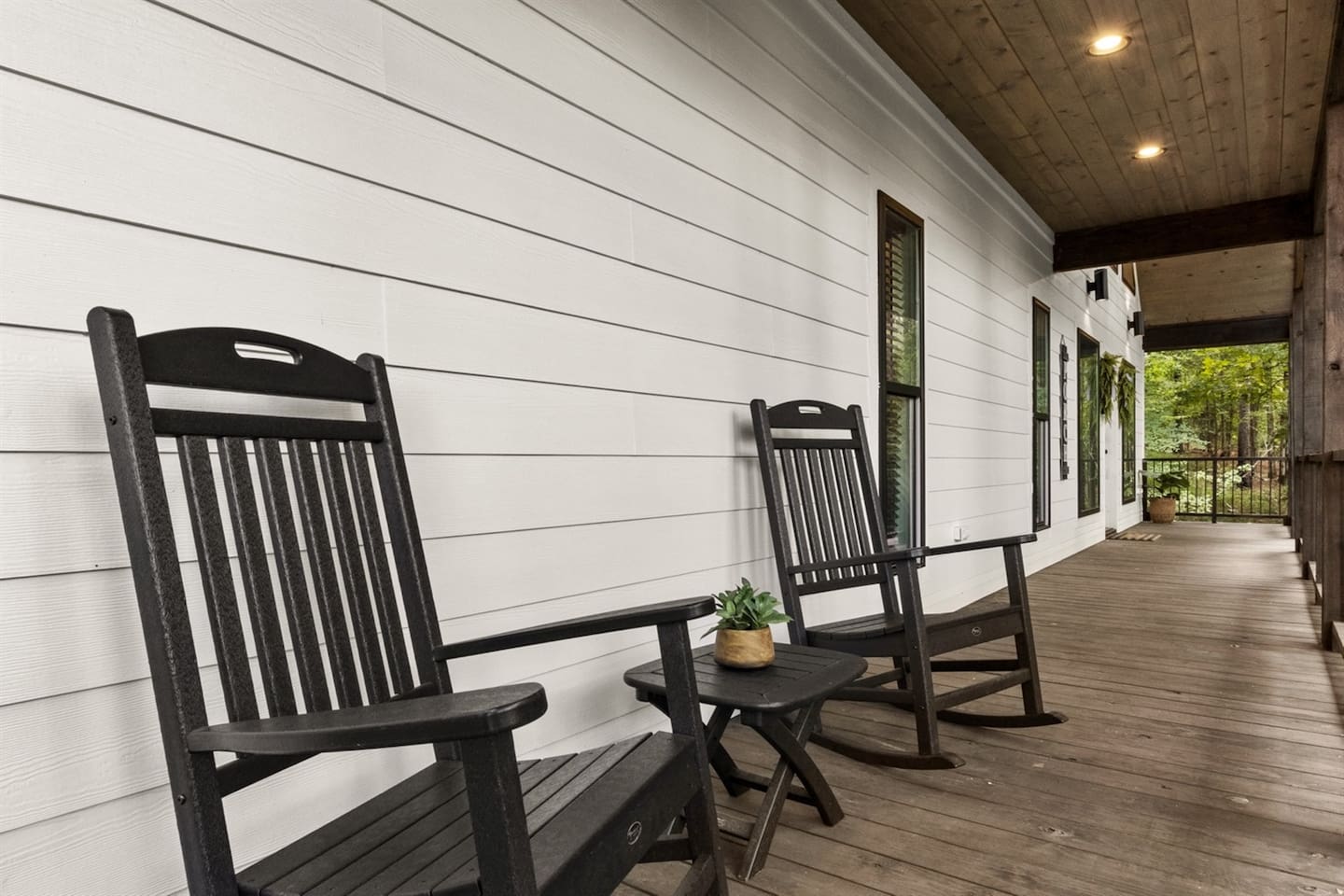 Relax on the covered deck’s cozy bistro seating or by the outdoor fireplace—perfect spots to unwind and enjoy peaceful forest views.